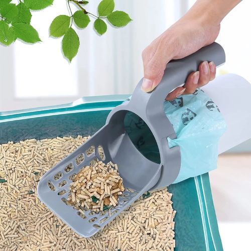 Person using a gray cat litter scoop to clean litter box with attached waste bag